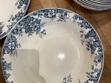 a lot of blue and white plates on the floor