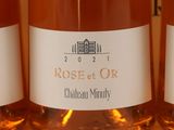 three bottles of rose wine are lined up on a table
