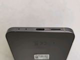 a close up of the back of a cell phone on a white surface