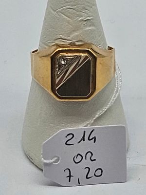 a gold ring with a black stone on it