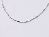 a white gold necklace with a curved link on a white background