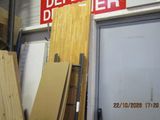 several pieces of wood are stacked up in front of a door