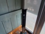 a tall tower with a clock on top of it in front of a door