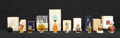 many different types of perfume bottles lined up on a black surface