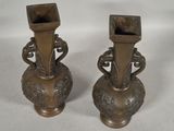 two vases that are sitting on a table