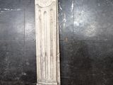 an old white fireplace mantle sitting on a black tile floor