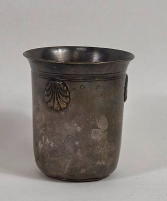 a silver cup that is sitting on a table