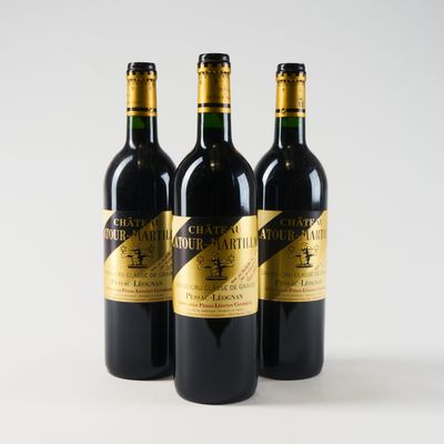 three bottles of wine sitting on top of a white table