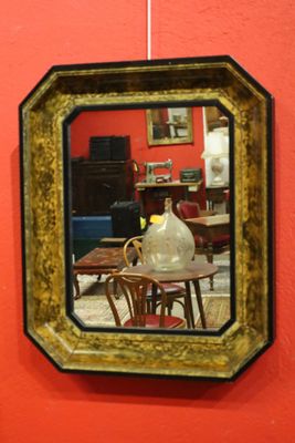 a mirror hanging on the wall above a table
