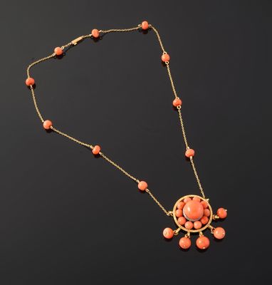 a necklace with coral beads and a gold chain