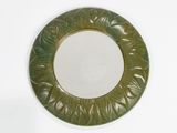 a green plate with a circular design on it