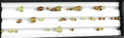 many different colored stones in a black box on a table