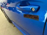 a close up of a car door handle with a sticker on it