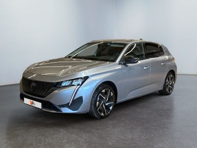 a silver car parked in a room with a white wall