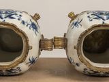 two vases that are sitting on a table