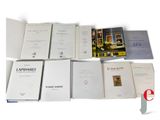 several books are stacked on top of each other on a table