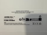 the back of a white laptop with a black and white sticker on it