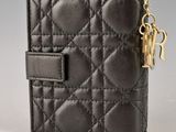 a black leather wallet with a gold chain hanging from the front