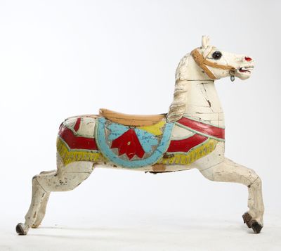 a toy horse that is standing on a white surface
