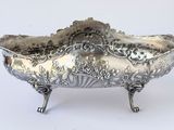 a silver bowl that is sitting on a stand