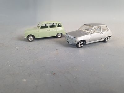 two toy cars that are sitting next to each other