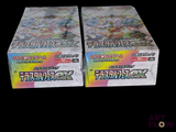 two boxes of pokemon trading cards on a black background