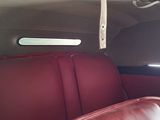 a red leather seat in the back of a car