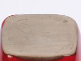 a red stool with a wooden seat on a white surface