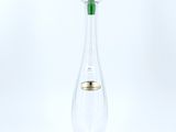 a green glass vase with a green stem sitting on top of a green base