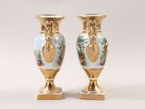 two vases that are sitting on a table