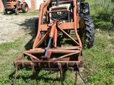 a small tractor that is parked in the grass