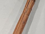 a wooden stick that has been carved into the side of it