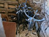 a pile of bikes that are sitting in the corner of a room