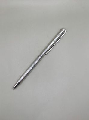 a pen that is laying on a white surface