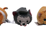 three stuffed animals sitting next to each other on a white surface