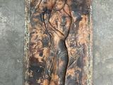 an image of a sculpture of a woman on a wall