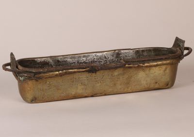 an old metal tray with a handle and handles