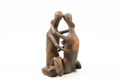 sculpture représentant un couple s'étreignant sur un fond blanc