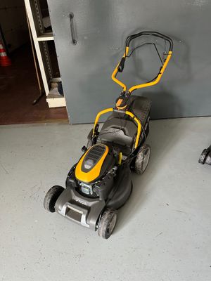 a yellow and black lawn mower sitting on the floor