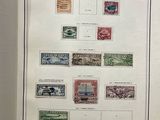 an open book with a bunch of stamps on it sitting on a table