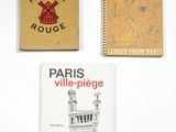 three books sitting on top of a white table next to each other