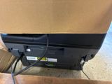 a black printer sitting on top of a brown box