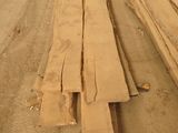 many pieces of wood sitting on the side of the road