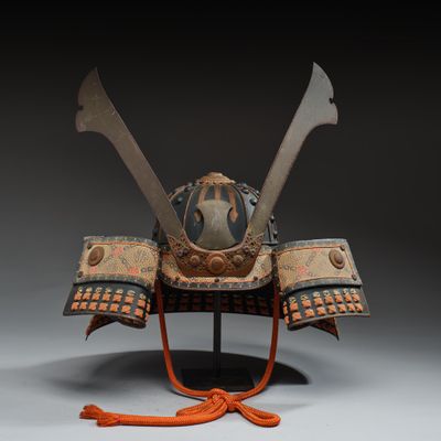 a close up of a helmet on a stand with two swords