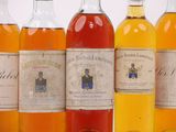 several bottles of alcohol are lined up in a row
