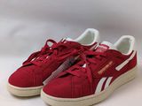 a pair of red sneakers with white laces on them