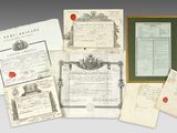 a group of old papers and other items sitting on top of a table