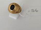 a close up of a gold ring with a black stone on it