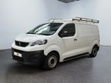 the white van is parked in a large room with a black floor