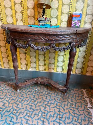 a wooden table with a lamp on top of it